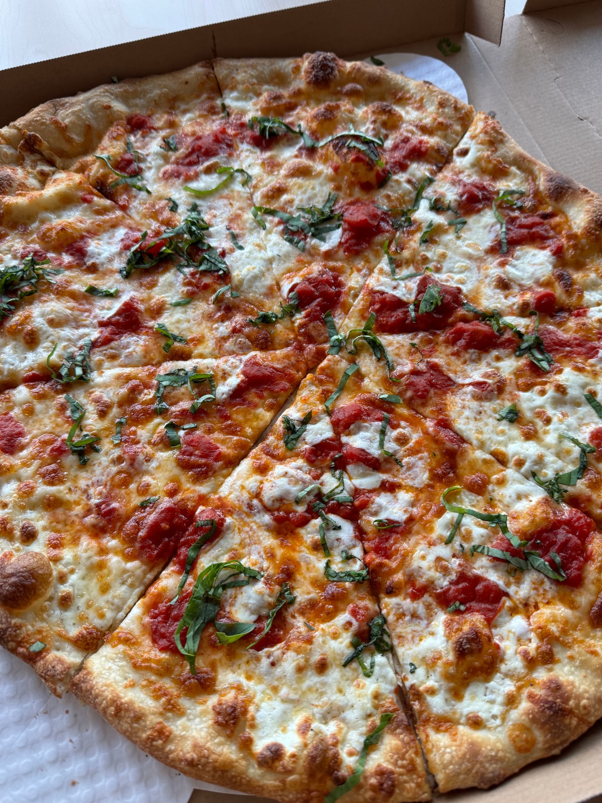 New York style Margherita pizza with mozzarella, crushed tomato, and fresh basil from Uncle G's